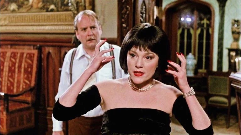 A still from the movie Clue featuring Madeline Kahn as Miss White